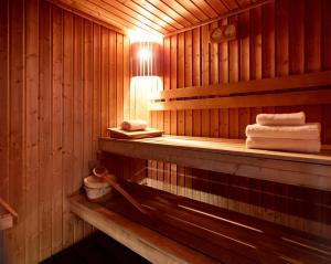 a wooden sauna with towels on a shelf in it at Athens Zafolia Hotel in Athens