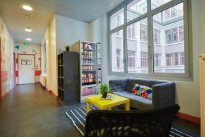 a living room with a couch and a table at St Christopher's Budget Hotel Paris - Gare du Nord in Paris