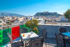 
a dining room table with chairs and a patio at Attalos Hotel in Athens
