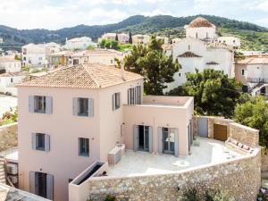 a villa with a view of a village at Maison Suisse with sea view in Spetses town in Spetses