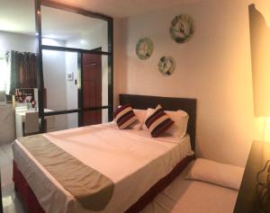 a bedroom with a bed with two pillows on it at The Blanket Hotel Restaurant & Coffee in Ilagan