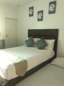 a bedroom with a large bed with two pillows at The Blanket Hotel Restaurant & Coffee in Ilagan