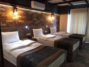 A bed or beds in a room at THE SARIGERME INN