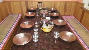 a group of bowls and glasses on a table at Salom Homestay Namche Bazar in Namchi