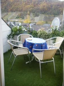 a table and chairs on a balcony with a view at Ferienwohnung M. Lemmermeyer in Neumagen-Dhron