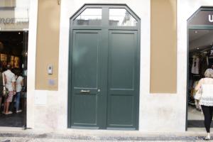 a green door on the side of a store at Augusta Street 213 - 2 Dto in Lisbon
