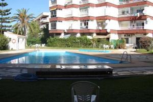 a swimming pool in front of a apartment building at Apartamento Neptuno in Nerja