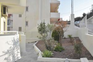 a courtyard with plants on the side of a building at Double M near Athens Airport in Markopoulo