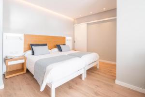 Giường trong phòng chung tại Hotel Eden Soller