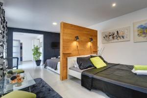 a bedroom with a large bed with a wooden headboard at Holiday Home Zoya in Ližnjan