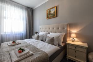Postel nebo postele na pokoji v ubytování SlaBur Residence