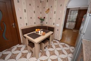 a kitchen with a small table with fruit on it at Villa Lazika in Borjomi