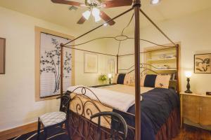 a bedroom with a canopy bed with a fan at Barrio Casita 2 in Tucson