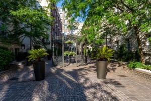 a sidewalk with potted plants on a city street at Les Jardins Du Marais in Paris