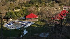 an overhead view of a swimming pool with a red roof at Prakriti Farms in Rūpnagar