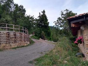 a dirt road next to a stone wall at Casa Beghino in Lama Mocogno