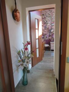 a hallway with a vase with flowers in it at Casa Beghino in Lama Mocogno