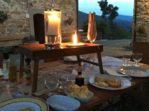 a table with a candle and some plates of food at Casa Beghino in Lama Mocogno