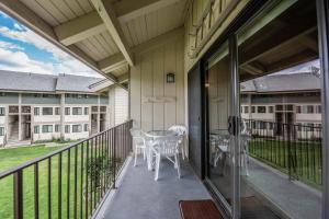 a balcony with a table and chairs on it at Condo Del Sol 210 in Sandpoint