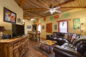 a living room with a couch and a flat screen tv at Barrio Casita 1 in Tucson