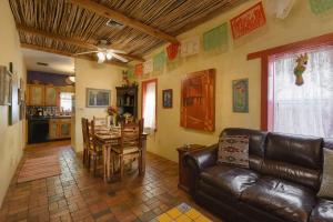 a living room with a leather couch and a table at Barrio Casita 1 in Tucson