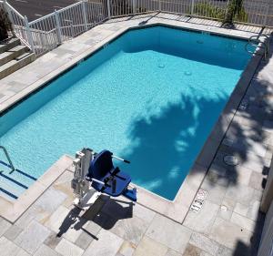 a swimming pool with a chair in front of it at Best Western Plus Marina Shores Hotel in Dana Point