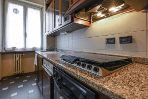 a kitchen with a stove and a counter top at PrimoPiano - Ciardi in Milan
