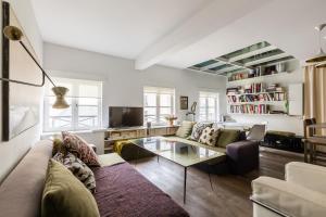 a living room with a couch and a coffee table at Veeve - Retro Cool on Rue Saint Paul in Paris