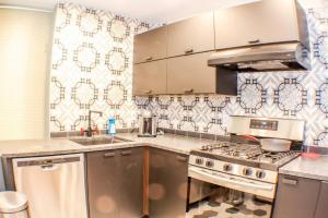 a kitchen with a sink and a stove top oven at ⭐️Trendy Apartment⭐️Fishtown⭐️ in Philadelphia
