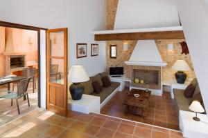 a living room with a couch and a fireplace at Can Noves - Villa de 3 Suites in Sant Francesc Xavier