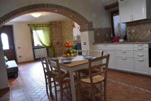 a kitchen with a table with fruit on it at Oasi delle Gazze in Genga
