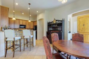 uma cozinha e sala de jantar com uma mesa de madeira e cadeiras em Casa San Miguel em Tucson