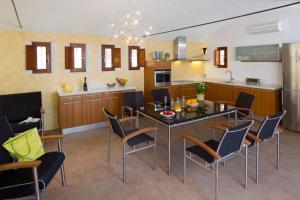 een keuken en eetkamer met een tafel en stoelen bij CAN NOVES - Villa de 2 suites (3) in Sant Francesc Xavier