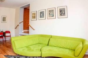 a green couch sitting in a living room at ⭐️Trendy Apartment⭐️Fishtown⭐️ in Philadelphia