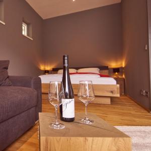 a bottle of wine sitting on a table with two wine glasses at kalmuck LOFT in Spitz