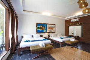 Letto o letti in una camera di Ubud Raya Boutique Hotel