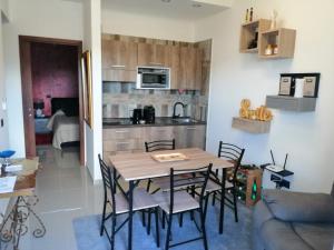 a kitchen and dining room with a table and chairs at E-Noa Holiday Home in Pompei