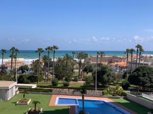 a view of a resort with a swimming pool and the beach at Apartamento Aqua Nature Delfin in La Mata