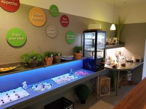 a store with a blue counter with dishes on it at Bed and Breakfast Zeulenroda in Zeulenroda