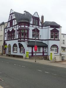 a large white building on the side of a street at Pension ZWO16 in Zeulenroda