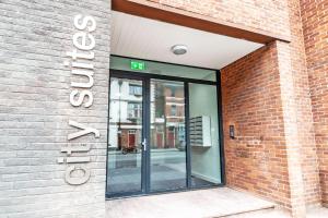 an entrance to a building with a revolving door at City Suites in Chester