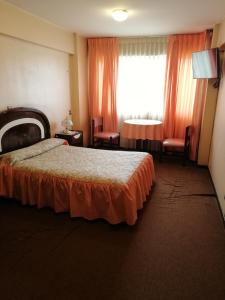 Hotel La Joya tesisinde bir odada yatak veya yataklar