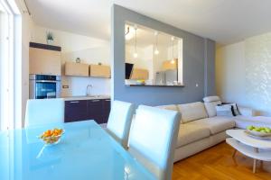 a living room with a table and a couch at Copacabana Apartment Dubrovnik in Dubrovnik