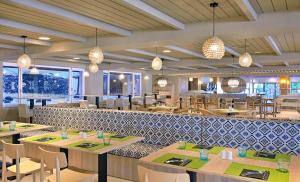 a restaurant with tables and chairs and lights at Sol Marbella Estepona Atalaya Park in Estepona