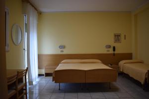 Postel nebo postele na pokoji v ubytování Hotel Martinez