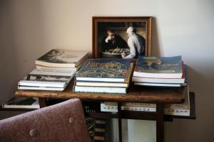 a pile of books sitting on top of a table at Chez Jules et Léonie in Valmondois