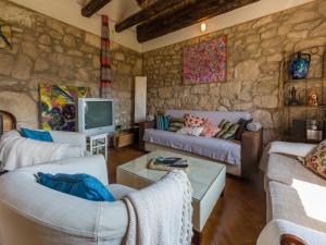 a living room with two couches and a tv at House VILLA NINA in Tribalj