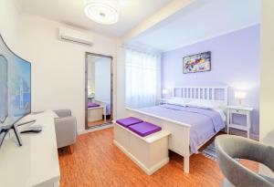 a bedroom with a bed and a desk and a mirror at Dubrovnik Colors - Old Town View Apartment No1 in Dubrovnik
