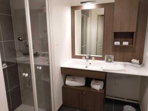 a bathroom with a sink and a shower at Domitys Le Pont des Lumières in Lyon