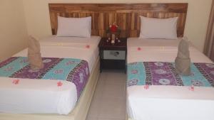 Ένα ή περισσότερα κρεβάτια σε δωμάτιο στο Intan Inn Hostel